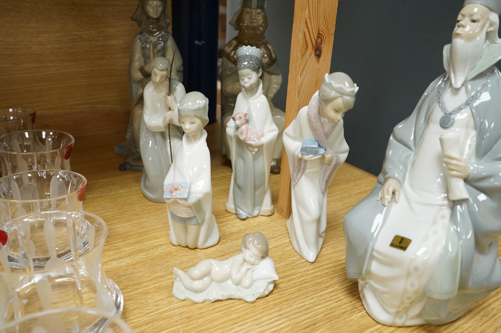 A group of Lladro figures Lord & Lady and a Chancellor, 3 Kings, Joseph with Staff and a recumbent child (8)